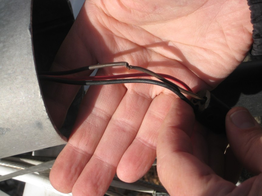 The top wire is staying together by a single strand.