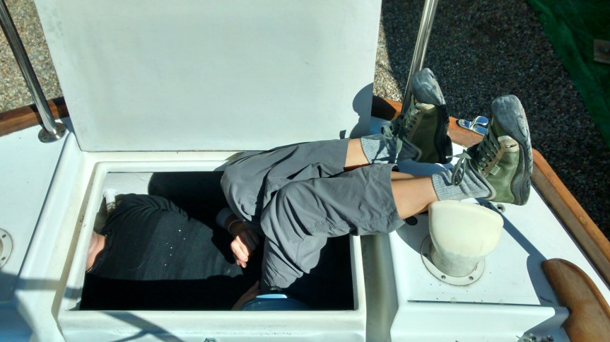 The choice is for Jeff to reach in with his long arms, but have to do it blind because he can't see the area we're working in, or for me to squeeze in and out of the rear lazarette. 